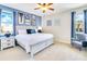 Stylish bedroom with a king-sized bed, modern decor, and ample natural light creates a cozy retreat at 7647 Fairfax Dr, Kissimmee, FL 34747