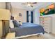 Bedroom featuring a queen bed, cool tones, and a wall-mounted television at 7647 Fairfax Dr, Kissimmee, FL 34747