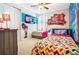 Charming bedroom with two beds, fun wall decor and a flat screen television at 7647 Fairfax Dr, Kissimmee, FL 34747