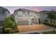Beautiful two-story home featuring a brick driveway, two-car garage, and well-maintained landscaping at 7647 Fairfax Dr, Kissimmee, FL 34747
