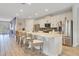 Spacious kitchen showcasing white cabinets, stainless steel appliances, and a large center island with seating at 7647 Fairfax Dr, Kissimmee, FL 34747