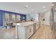 Open kitchen with a large island, stainless steel appliances, and an adjacent dining area at 7647 Fairfax Dr, Kissimmee, FL 34747