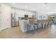 Bright kitchen featuring stainless steel appliances, white cabinetry, and a breakfast bar with seating at 7647 Fairfax Dr, Kissimmee, FL 34747