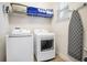 Functional laundry room with a washer, dryer, and storage space at 7647 Fairfax Dr, Kissimmee, FL 34747