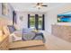 Comfortable main bedroom with a large bed, ceiling fan, and direct access to the backyard pool area at 7647 Fairfax Dr, Kissimmee, FL 34747