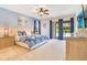 Cozy main bedroom featuring a plush bed, a ceiling fan, and private access to an outdoor pool area at 7647 Fairfax Dr, Kissimmee, FL 34747