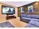 Home movie room featuring a comfortable sectional couch and a large flat screen TV at 7647 Fairfax Dr, Kissimmee, FL 34747