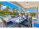 Outdoor dining area next to the pool with patio furniture and landscaping at 7647 Fairfax Dr, Kissimmee, FL 34747