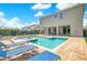 Backyard pool and spa with lounge chairs offering a relaxing outdoor retreat at 7647 Fairfax Dr, Kissimmee, FL 34747