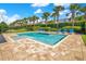 Community pool with lounge chairs and neatly trimmed landscaping on a sunny day at 7647 Fairfax Dr, Kissimmee, FL 34747