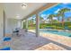 Covered patio with dining and lounging overlooking the pool, ideal for relaxing and entertaining at 7647 Fairfax Dr, Kissimmee, FL 34747