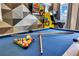 Well maintained pool table with balls and cues ready for a game at 7647 Fairfax Dr, Kissimmee, FL 34747
