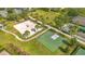 Aerial view of the recreation area featuring a beach volleyball court, basketball court, and green spaces at 7647 Fairfax Dr, Kissimmee, FL 34747