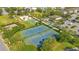 Aerial view of the tennis courts, green spaces, and parking areas in the recreation area at 7647 Fairfax Dr, Kissimmee, FL 34747