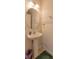 Powder room featuring pedestal sink, oval mirror, and paneled walls at 87 Delacorte Way, Oviedo, FL 32765