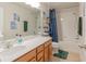 Bright bathroom showcasing a vanity, ample mirror, tub/shower combination, and contemporary fixtures at 87 Delacorte Way, Oviedo, FL 32765