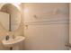 This powder room features paneled walls, a pedestal sink, and neutral colors at 87 Delacorte Way, Oviedo, FL 32765