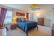 Comfortable bedroom with a queen bed, ceiling fan, and soft carpeting at 87 Delacorte Way, Oviedo, FL 32765