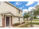 Charming townhome entrance featuring a brick pathway and well-maintained landscaping at 87 Delacorte Way, Oviedo, FL 32765