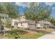 Beautiful two-story townhome with a brick driveway and a well-maintained lawn at 87 Delacorte Way, Oviedo, FL 32765