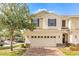 Charming townhome featuring a brick driveway and a two-car garage at 87 Delacorte Way, Oviedo, FL 32765
