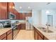 Modern kitchen featuring granite countertops, stainless steel appliances, and ample cabinet space at 87 Delacorte Way, Oviedo, FL 32765