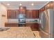 Modern kitchen features granite counters, stainless steel appliances, and ample cabinetry at 87 Delacorte Way, Oviedo, FL 32765