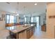 Open-concept kitchen boasts a large island and seamlessly connects to the living area at 87 Delacorte Way, Oviedo, FL 32765