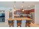 Stylish kitchen featuring granite countertops, a large island, and stainless steel appliances at 87 Delacorte Way, Oviedo, FL 32765