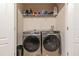 Laundry closet featuring side by side washer and dryer on tile with shelving at 87 Delacorte Way, Oviedo, FL 32765