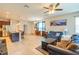 Spacious living room with lots of natural light connected to the kitchen and dining areas at 87 Delacorte Way, Oviedo, FL 32765