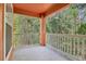 Relaxing balcony with white railings offering a view of lush greenery and trees at 8824 Villa View Cir # 204, Orlando, FL 32821