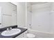 Clean bathroom with a shower/tub and a black countertop vanity at 8824 Villa View Cir # 204, Orlando, FL 32821