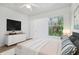 Spacious bedroom featuring a ceiling fan, dresser, and a large view of the wooded landscape at 8824 Villa View Cir # 204, Orlando, FL 32821