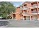 Exterior of a multi-story building with garages, balconies, and well-manicured landscaping at 8824 Villa View Cir # 204, Orlando, FL 32821