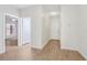 Bright hallway with wood-look flooring and white walls leading to various rooms at 8824 Villa View Cir # 204, Orlando, FL 32821