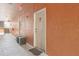 Hallway with an apartment door and a small bench on a bright sunny day at 8824 Villa View Cir # 204, Orlando, FL 32821