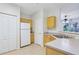 Well-lit kitchen featuring an open concept and bright white appliances at 8824 Villa View Cir # 204, Orlando, FL 32821