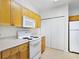 Efficient kitchen with white appliances and ample cabinet space at 8824 Villa View Cir # 204, Orlando, FL 32821