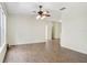 Open-concept living room with hardwood floors and a ceiling fan, showcasing the spacious design at 8824 Villa View Cir # 204, Orlando, FL 32821
