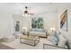 Bright living room with neutral decor, ceiling fan, and view of wooded landscape at 8824 Villa View Cir # 204, Orlando, FL 32821