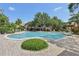 Community pool surrounded by lush landscaping and ample seating areas at 8824 Villa View Cir # 204, Orlando, FL 32821