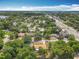Aerial view shows home among lush greenery, in a neighborhood close to a major roadway at 920 Gloriosa Ave, Winter Park, FL 32789