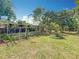 Expansive backyard featuring a screened-in patio and mature landscaping, perfect for outdoor entertaining and relaxation at 920 Gloriosa Ave, Winter Park, FL 32789