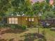 This backyard offers a serene, partially shaded space with trees, a small patio, and a well-maintained grassy area at 920 Gloriosa Ave, Winter Park, FL 32789