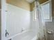 Neat bathroom featuring a tiled bathtub with shower and a floral shower curtain at 920 Gloriosa Ave, Winter Park, FL 32789