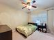 This bedroom features a ceiling fan, light filtering curtains, and a twin bed with dresser and nightstand at 920 Gloriosa Ave, Winter Park, FL 32789