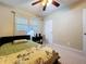 This bedroom features a ceiling fan, light filtering curtains, and a twin bed with reading lamp at 920 Gloriosa Ave, Winter Park, FL 32789