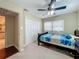 Bedroom with double closet, window, ceiling fan, and adjoining bathroom at 920 Gloriosa Ave, Winter Park, FL 32789