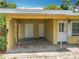 A well-kept carport with a concrete floor, storage doors, and direct access to the home's entrance at 920 Gloriosa Ave, Winter Park, FL 32789